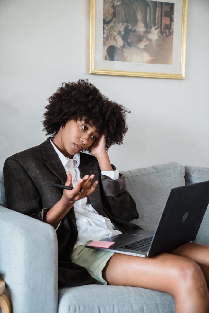 black woman stressed out working on laptop computer