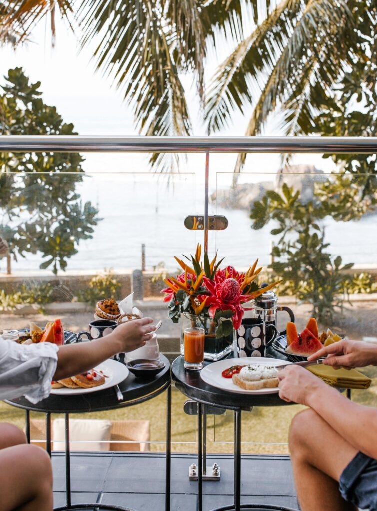 honeymoon couple enjoys breakfast on the balcony of their luxury resort in Cancun Mexico 